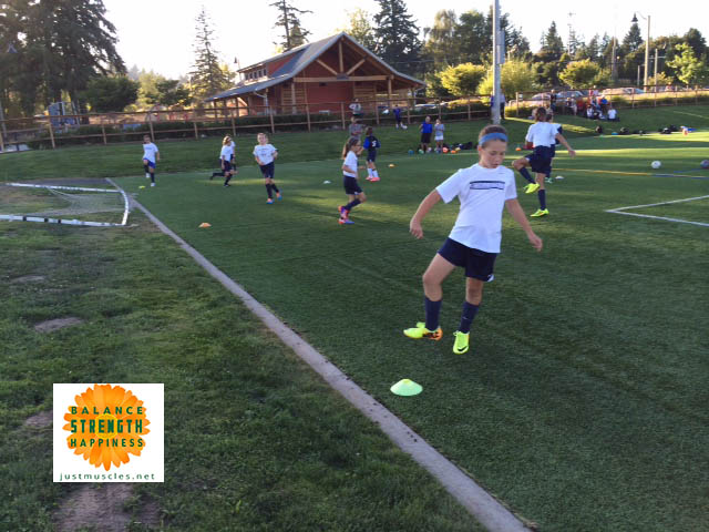 Image of girls moving during soccer warmups