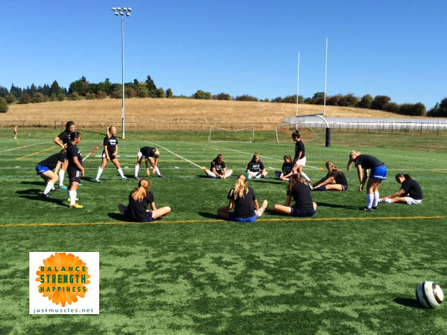 Image of a a group of girls doing a static warm up routine