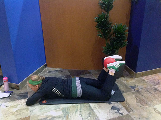 Image of Laura Coleman demonstrating prone ankle squeezes