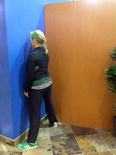 Image of Laura Coleman Demonstrating Sumo Squats against a wall start position