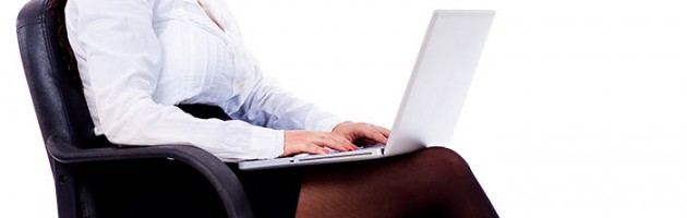 Business woman with a laptop sitting in an office chair