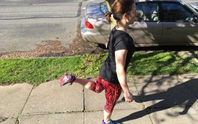 Image of woman-doing walking hamstring curls as part of pre exercise warmup routine