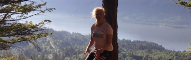 image of trainer Laura Coleman demonstrating an airbench exercise using a tree