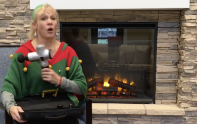 image of Laura Coleman Waite demonstrating the percussion gun for massage therapy