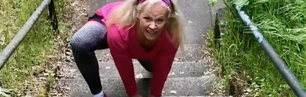 image of Laura Coleman Waite starting a bear crawl up stairs